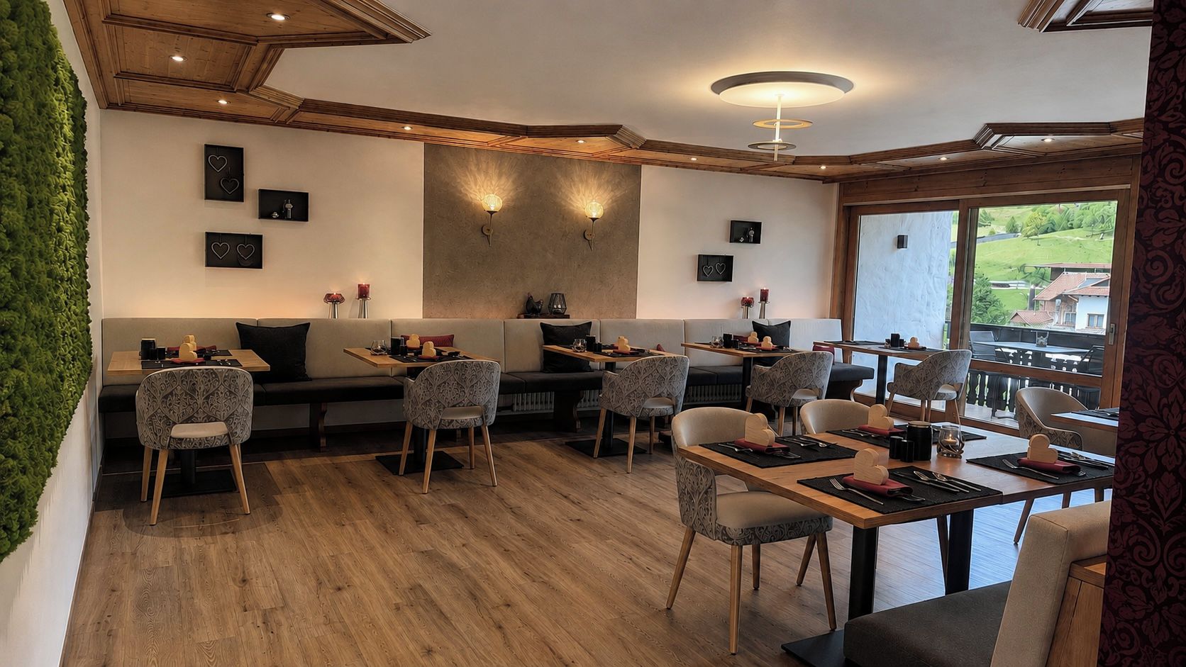 A restaurant with a wooden ceiling, wall-mounted lights, and a view of the outdoors.