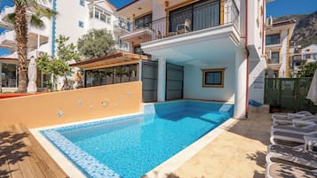 Seasonal outdoor pool, pool umbrellas, pool loungers