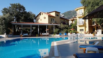 Seasonal outdoor pool, pool umbrellas, pool loungers