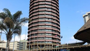 A cylindrical building with the Samsung logo at the top, surrounded by palm trees and a water feature. - LMS Guest House (Nairobi)