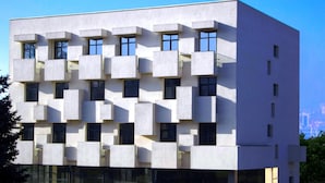 A modern building with a unique modular facade, large windows, and a glass entrance. - Wine Hotel (Chisinau)