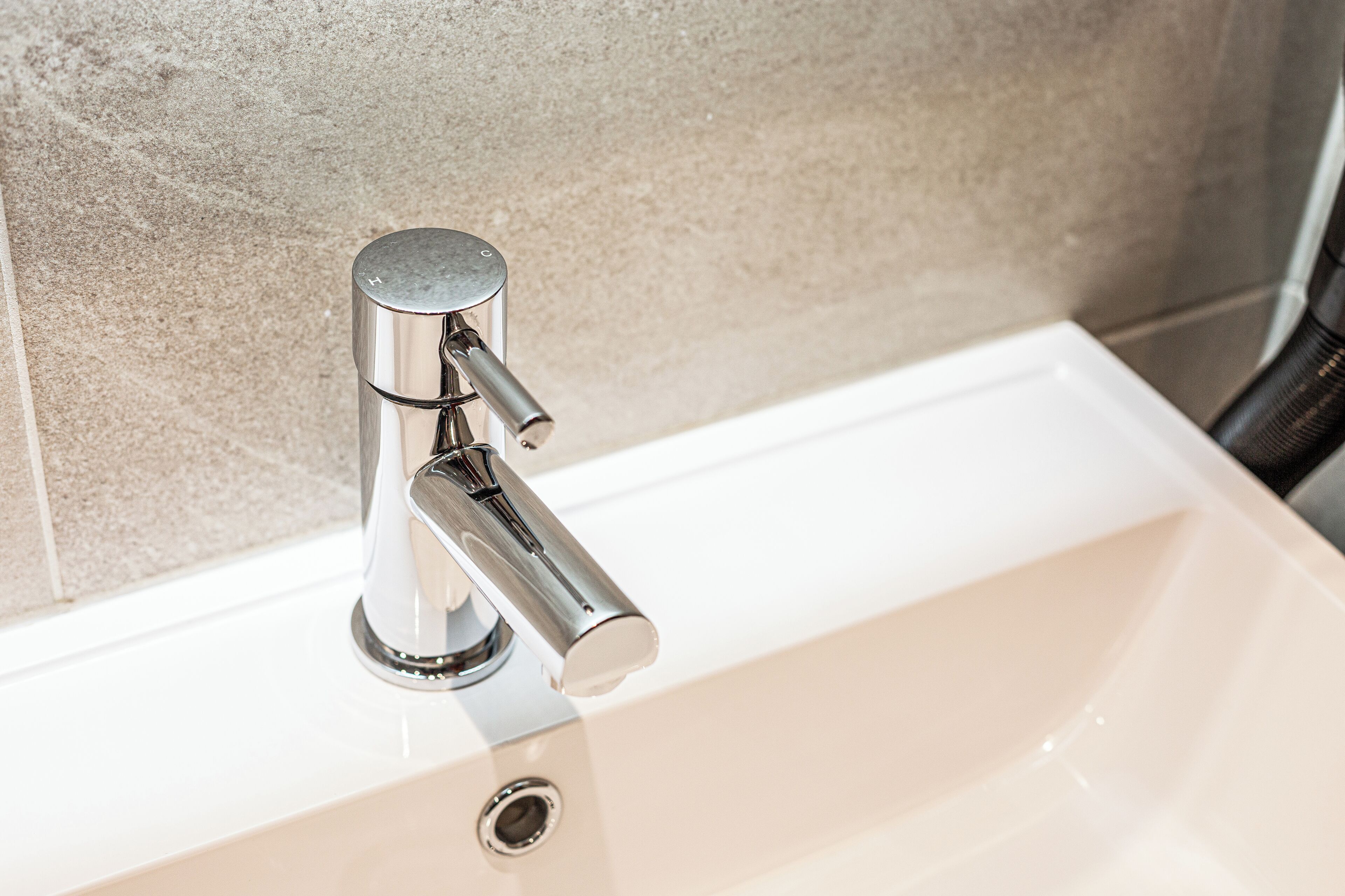 A modern bathroom sink with a chrome faucet and a single-handle design.