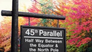 A sign indicating the location as the 45th Parallel, halfway between the Equator and the North Pole. - The Waters Inn (Gaylord)
