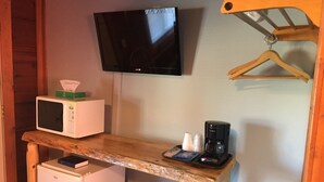 A compact kitchenette with a microwave, coffee maker, and a small refrigerator. - The Waters Inn (Gaylord)