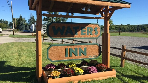 A wooden sign with the words "WATERS INN" and "EST. 2004" indicating the name and establishment year of the inn. - The Waters Inn (Gaylord)