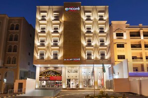 A multi-story hotel with a prominent entrance, balconies, and a flagpole. - Ramada Encore by Wyndham Al Khobar Olaya (Al Khobar)