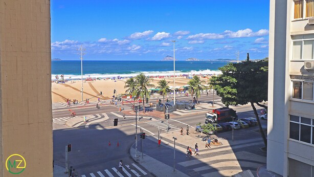 A view of a beach with palm trees and a crosswalk leading to the beach. - MZ Apartments Prado Junior (Rio de Janeiro)