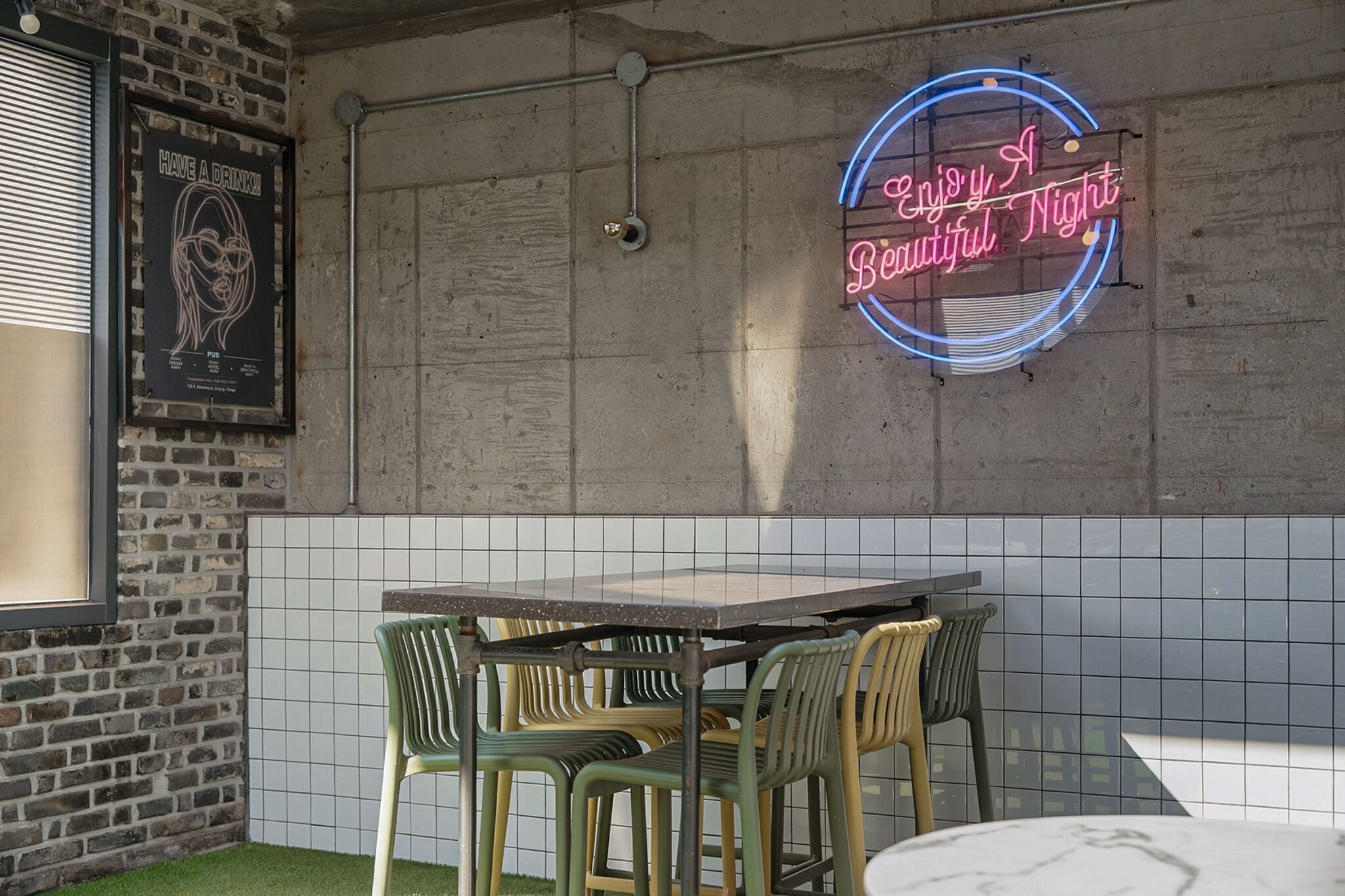 A brick wall with a neon sign that reads 'Enjoy a Beautiful Night.'
