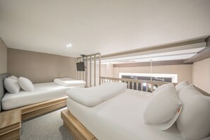 A modern bedroom with a large bed, a sofa, and a TV. - ACT Hotel Urban (Daegu)