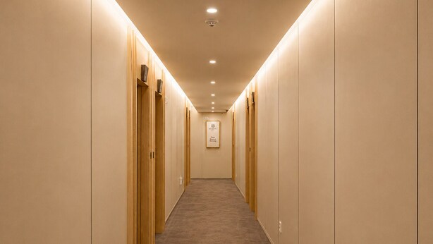 A hotel hallway with carpeted floors, wooden doors, and recessed lighting. - ACT호텔 어반 (Daegu)