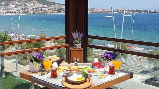 Una mesa de desayuno con vista al mar y al paisaje urbano.