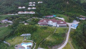 A large resort with multiple buildings, a swimming pool, and a well-maintained landscape. - Daea Ulleung Resort (Ulleung)