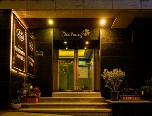 The exterior of Dae Young Hotel with a welcoming sign, a reception desk, and potted plants at the entrance. - Daeyoung Hotel Seoul (Seoul)