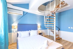 A bedroom with a bed, a nightstand, a lamp, an air conditioner, and a spiral staircase. - BSA Boulevard Boutique (Sunny Beach)