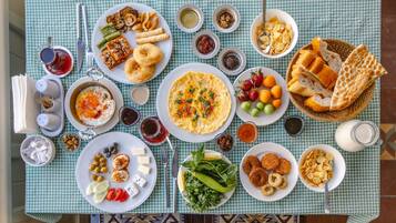 A table set with various dishes, including salads, bread, and a plate of eggs.