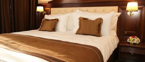 A hotel room with a large bed, two nightstands, and a headboard with a circular design.