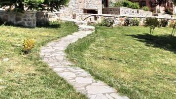 A stone building with a stone pathway leading to a door.