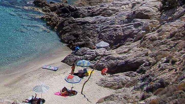 A coastal beach with rocky terrain and clear blue water. - OLIVIA VILLAS (Ikaria)