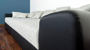 A modern sofa with a dark leather armrest and a light grey cushion. - Italianway   - Pastorelli (Milan)