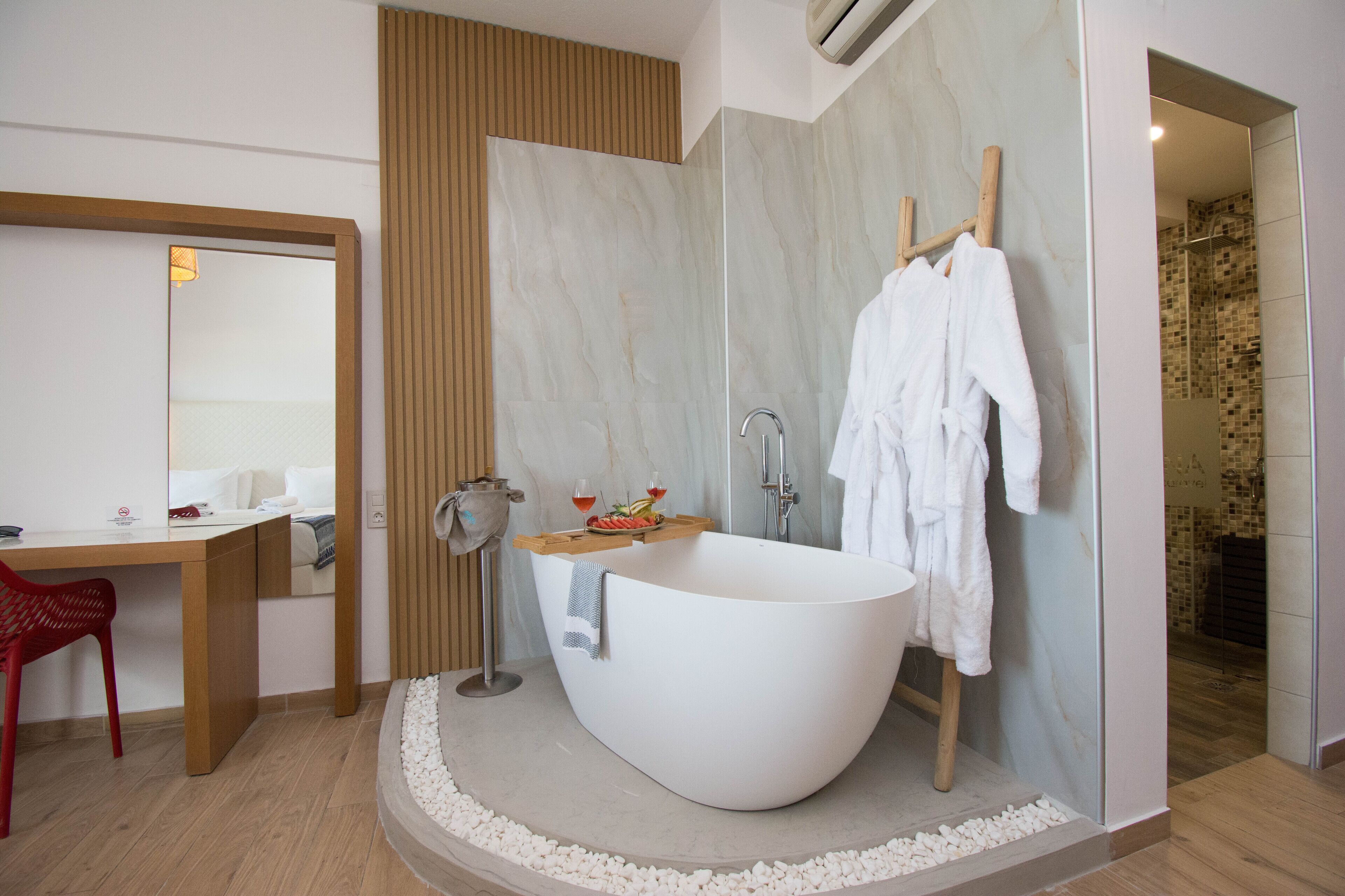 A modern bathroom with a freestanding bathtub, a shower area, and a vanity with a mirror.