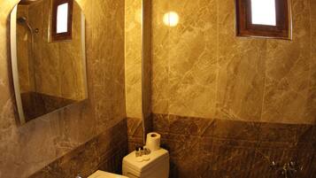 A bathroom with a sink, toilet, and shower.