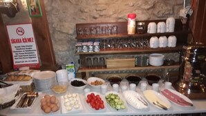 A buffet table with various food items and utensils. - Arifbey Konak Hotel (Safranbolu)