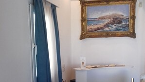 A staircase with black and white marble steps leading to a reception desk. - Hotel Esperides (Naxos)