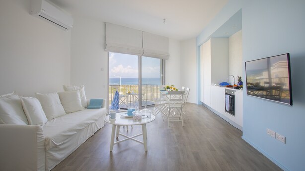 Living area | Flat-screen TV - Protaras Azure Seafront Suite (Paralimni)