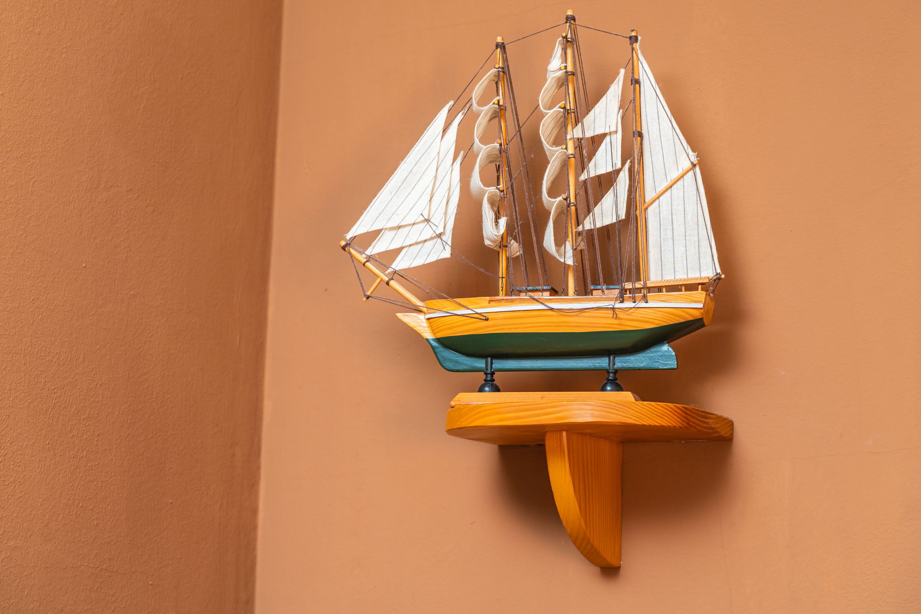 A model sailboat mounted on a wall.