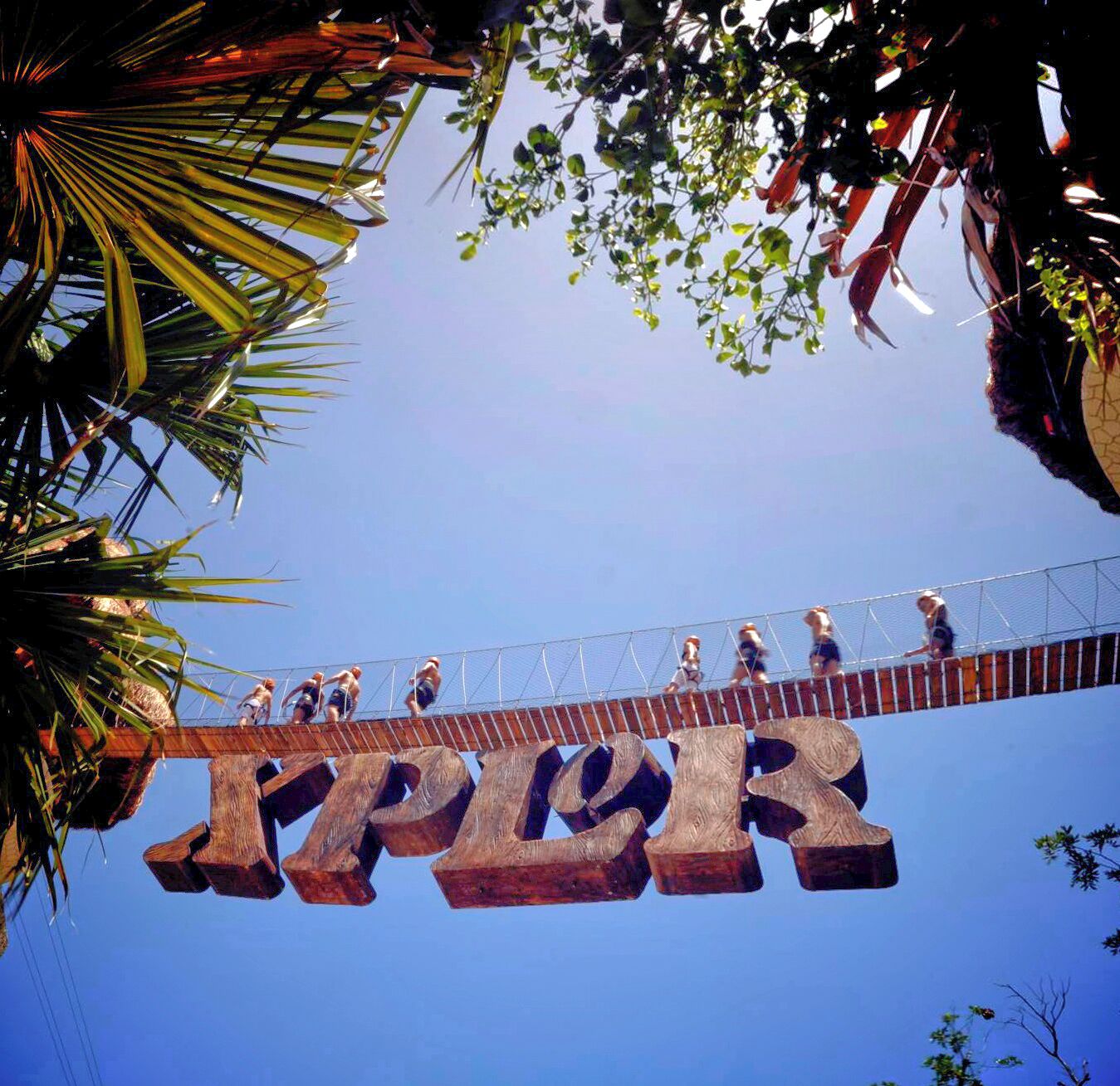 A wooden bridge with the word "ZIPPER" spelled out in large letters.