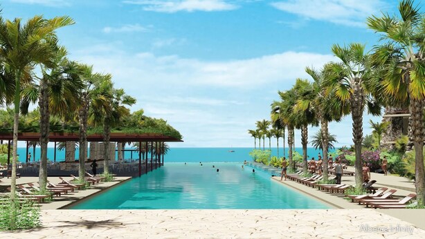 A pool with lounge chairs and palm trees, overlooking the ocean. - Hotel Xcaret Tierra - Family Premier - All inclusive (Playa del Carmen)