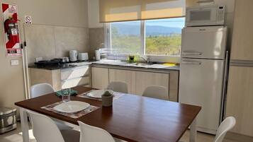 Comfort Apartment | Private kitchen | Microwave, electric kettle, toaster, cookware/dishes/utensils