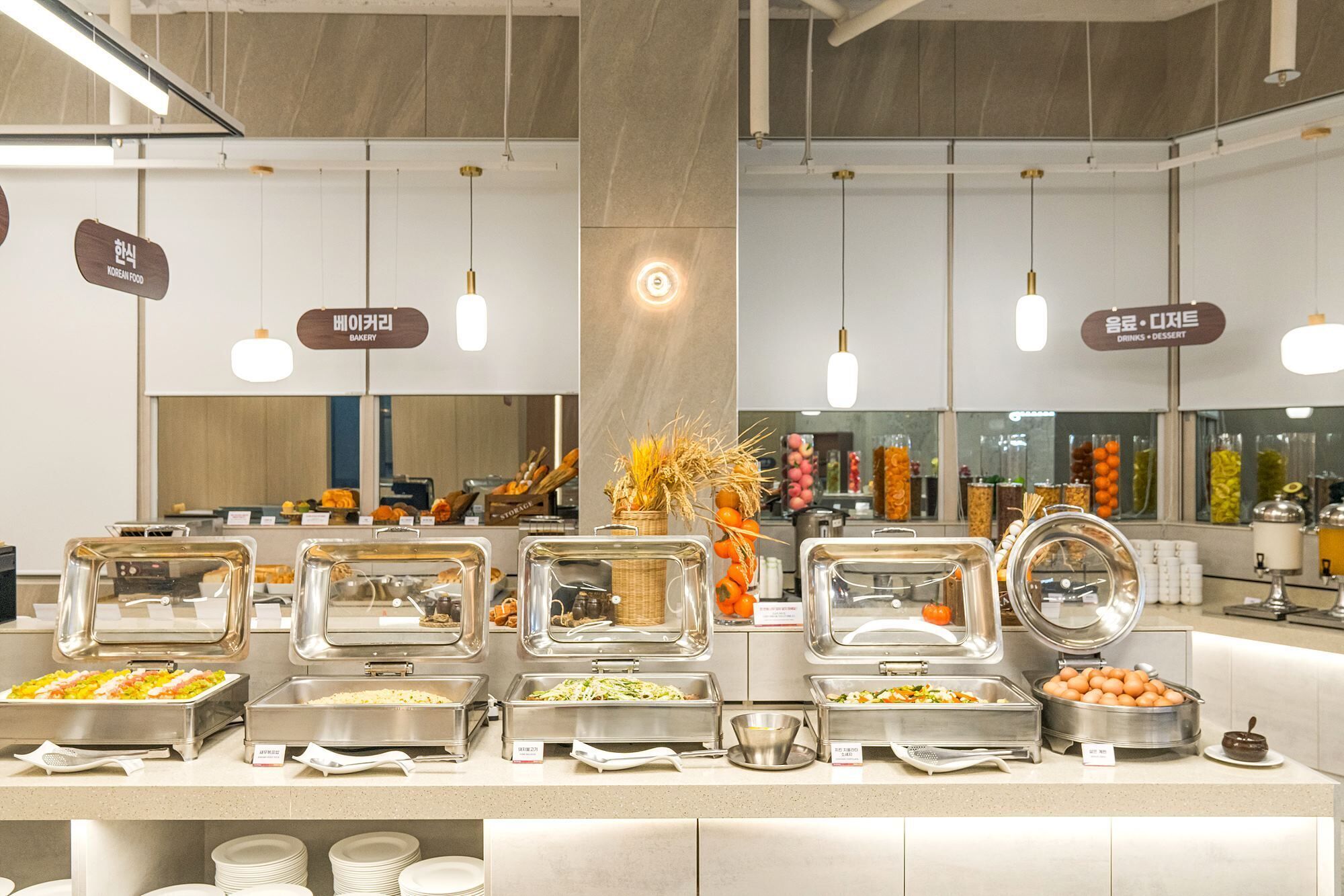 A buffet area with various food stations, including a bakery and a drinks section.