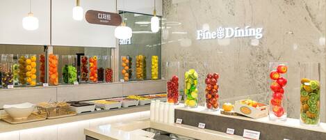 A food display area with various fruits and a sign for 'Fine Dining'.