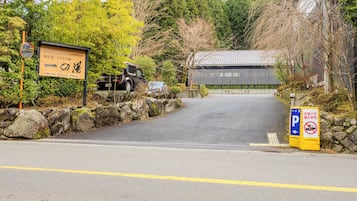 A parking area with a sign indicating a large parking space and a no-parking zone.