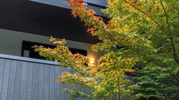 A modern building with a dark facade and a visible window.