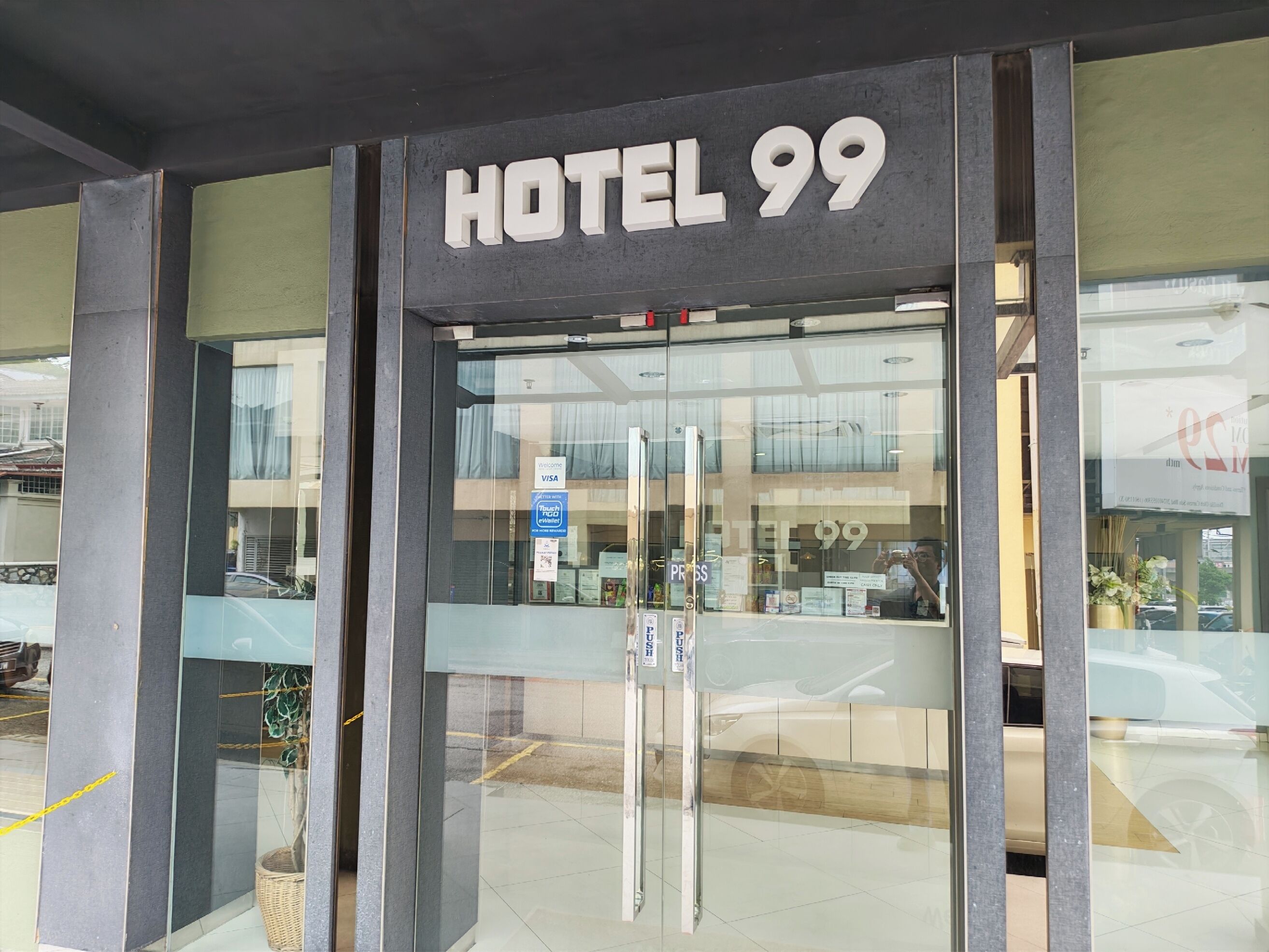 A hotel entrance with a sign reading 'HOTEL 99'.