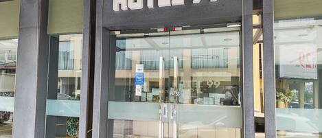 A hotel entrance with a sign reading 'HOTEL 99'.