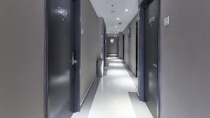 A modern hallway with doors marked 9227 and 9228, leading to rooms.