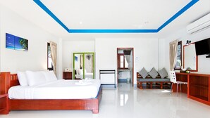 A modern hotel room with a wooden bed, a desk, a chair, and a sofa. - Breeze Bay Villa (Ko Pha-ngan)