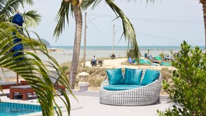 A poolside area with a white woven sofa, a small pool, and palm trees. - Breeze Bay Villa (Ko Pha-ngan)