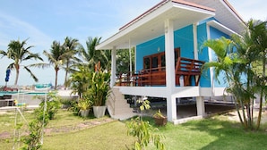 A two-story building with a covered porch, palm trees, and a pool in the background. - Breeze Bay Villa (Ko Pha-ngan)