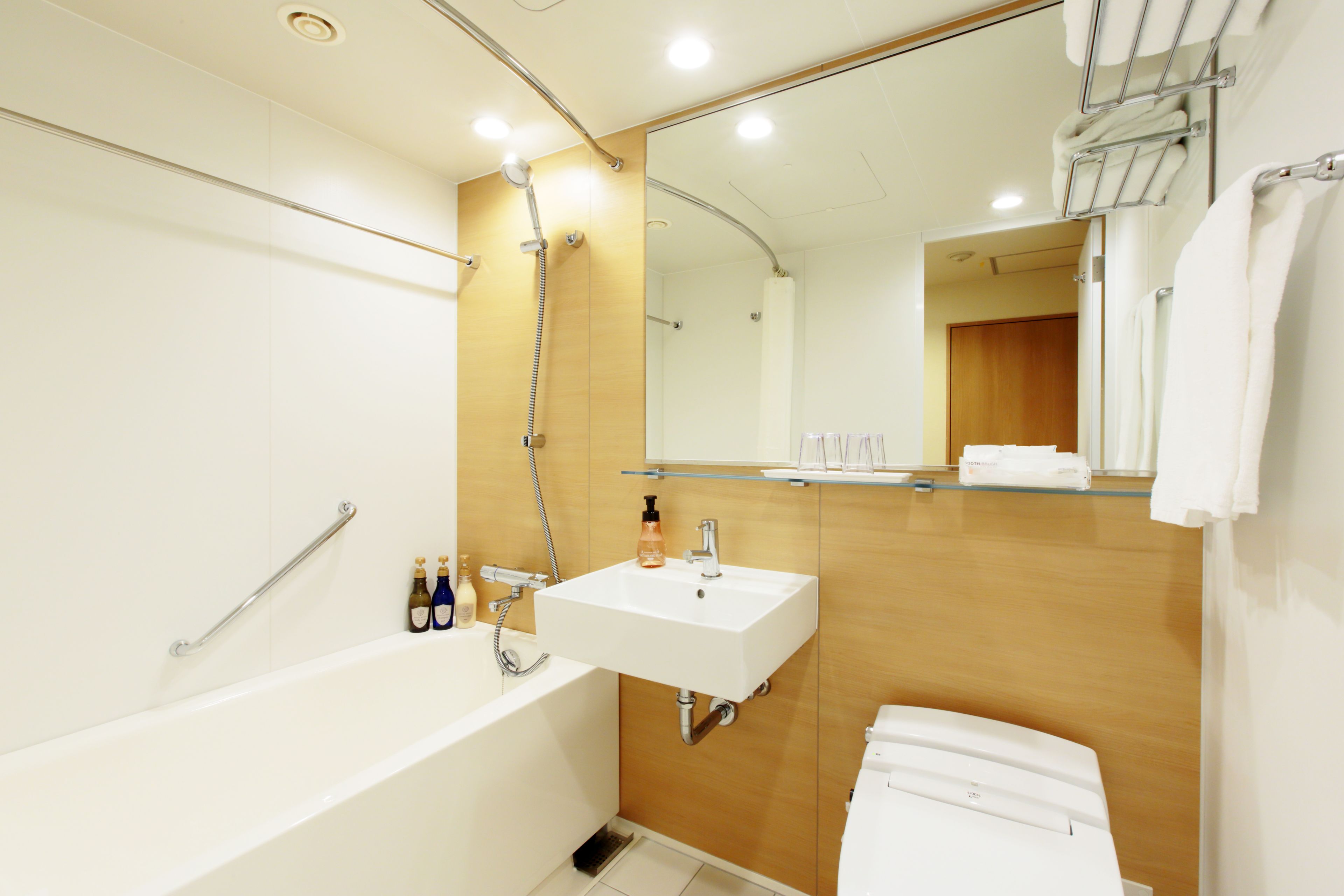 A modern bathroom with a bathtub, a sink, and a toilet.