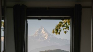A room with a view of a mountain range through an open doorway. - Tiger Mountain Pokhara Lodge (Pokhara)