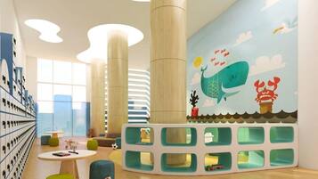 A children's play area with a mural, storage units, and seating.