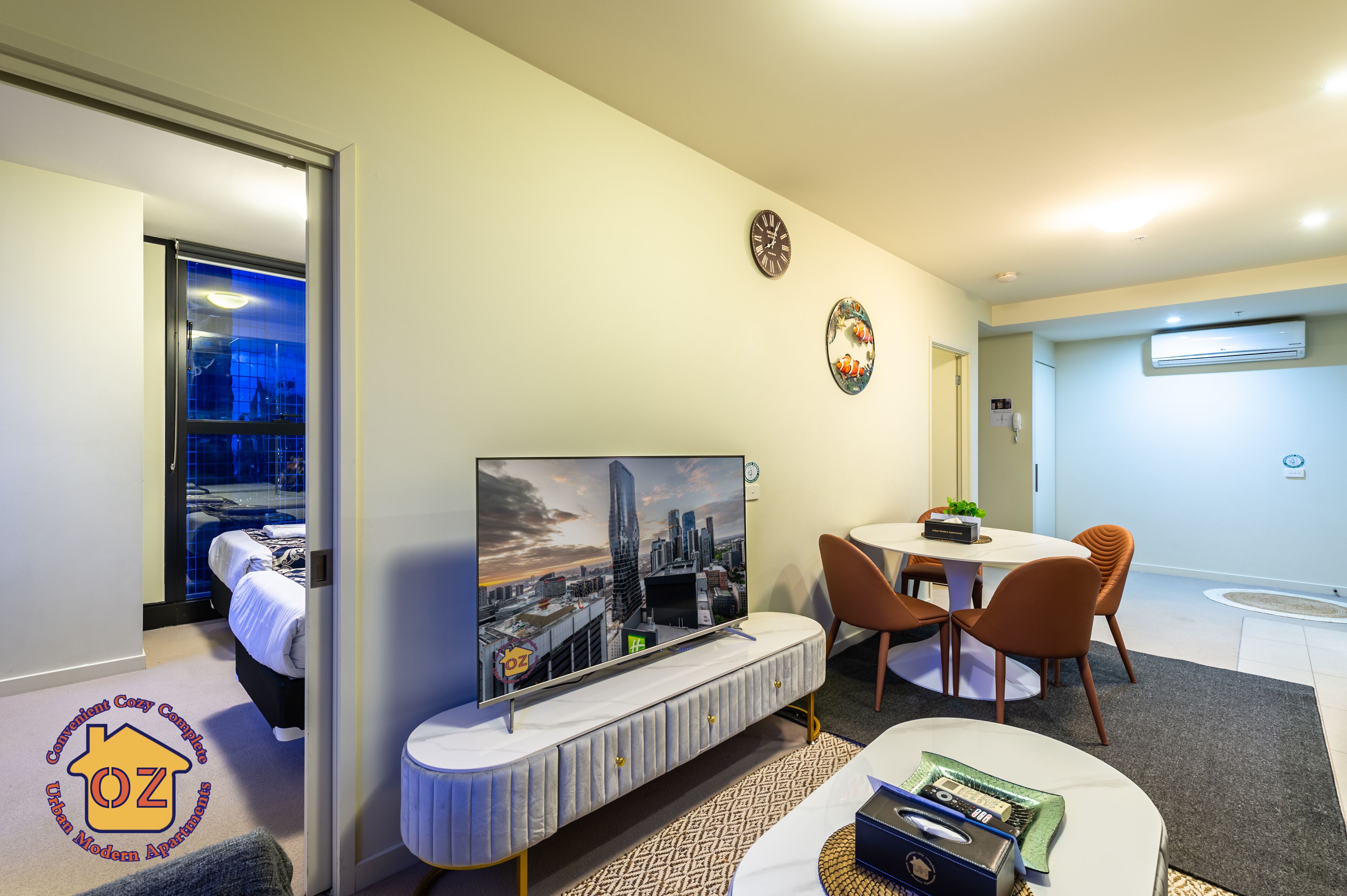 Une chambre d’hôtel moderne équipée d’un lit, d’une télévision, d’un coin repas et d’un système de climatisation.