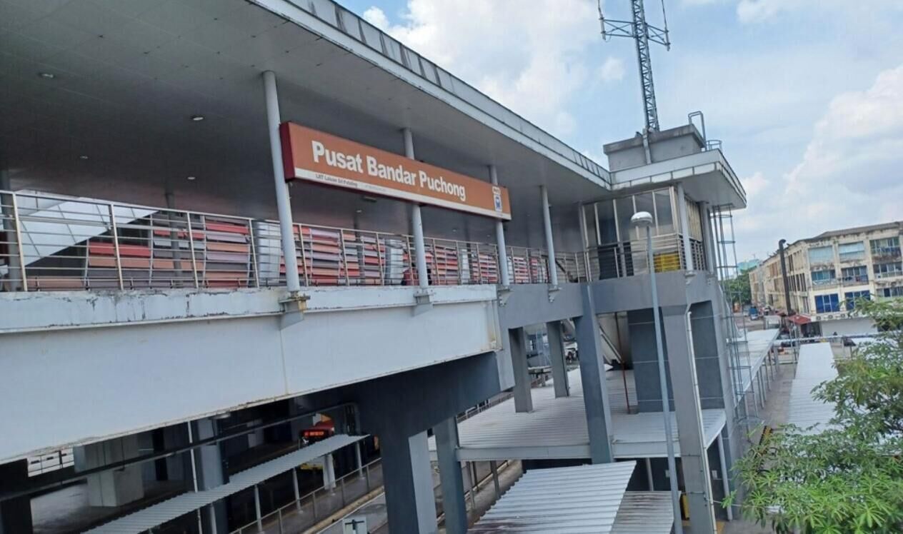 A multi-level structure with a sign reading 'Pusat Bandar Puchong.'