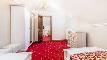 Ein Schlafzimmer mit rotem Teppich, einem weißen Bett, einem Schminktisch und einem Kleiderschrank.