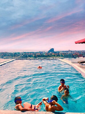 A swimming pool with a view of a cityscape in the background. - CKC Thien Duong Hotel (Dong Hoi)