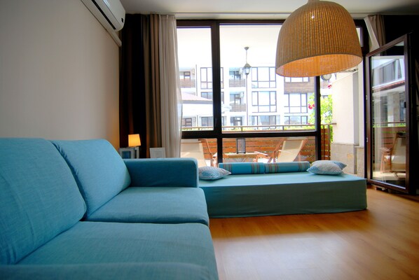 Design Apartment, 1 Bedroom, Terrace, Poolside | Living room | Flat-screen TV